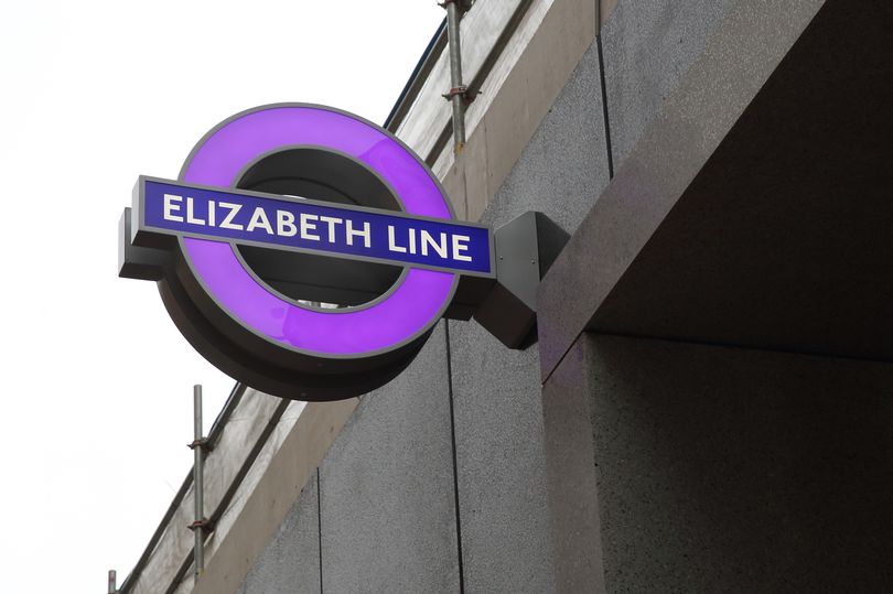 External shot of iconic London Underground signage (featuring purple Elizabeth Line)
