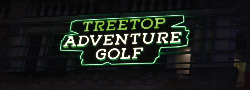 A night-time illuminated view of the signage for Treetop Advnture Golf